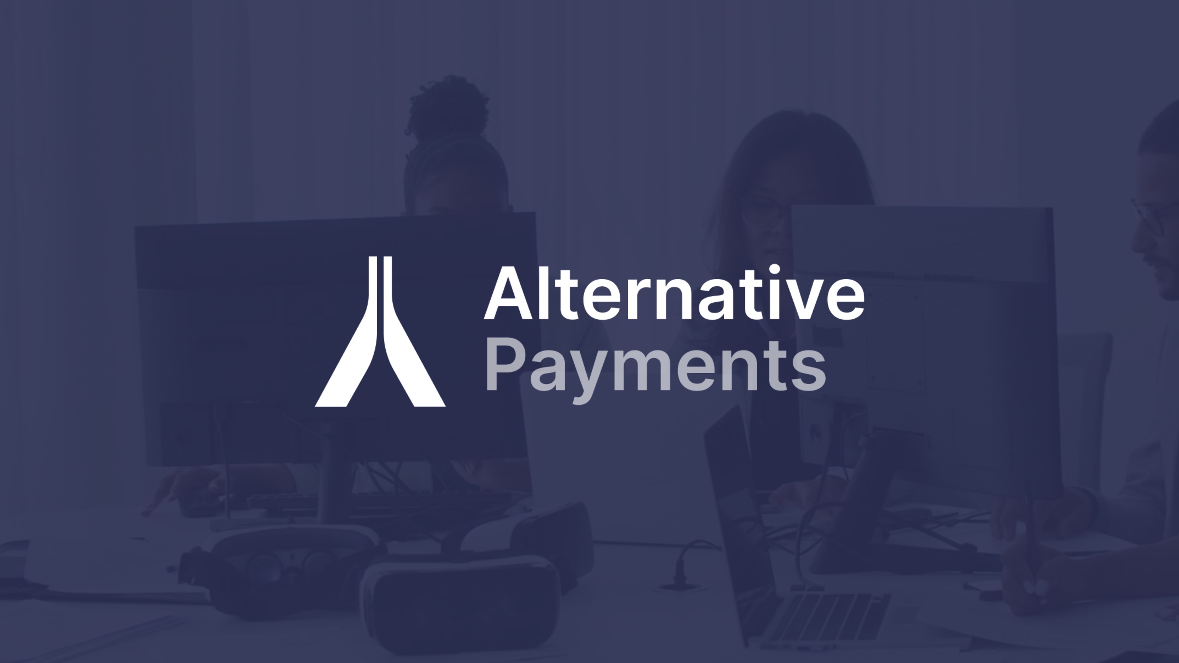 The image features an overlay of text reading "Alternative Payments" over a faded background. The background appears to show a modern office environment with people engaged in work, likely prioritizing MSP Customer Success. There are visible computer monitors, a VR headset on the desk, and individuals who seem to be collaborating or working on tasks. The people in the image are not in sharp focus, and their faces are not clearly visible, which maintains a professional aesthetic while emphasizing the text overlay.